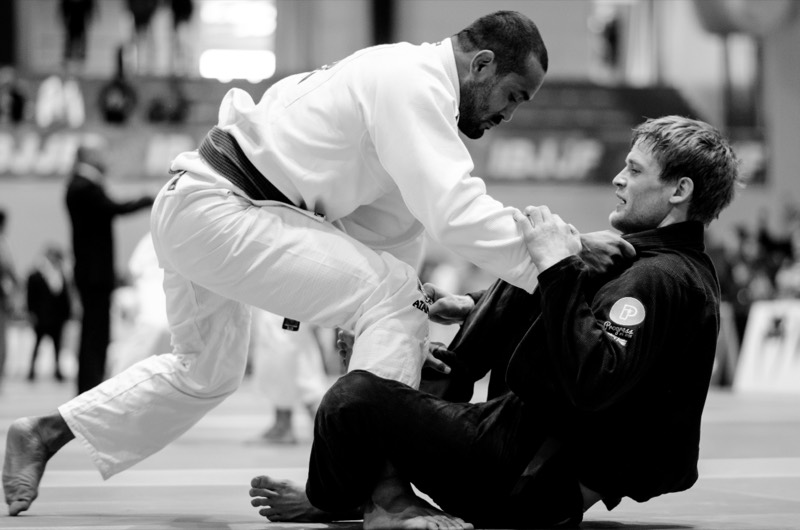 A black and white competition photo of one grappler passing another grappler's guard.